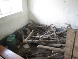 Firewood is stored in a corner of a classroom